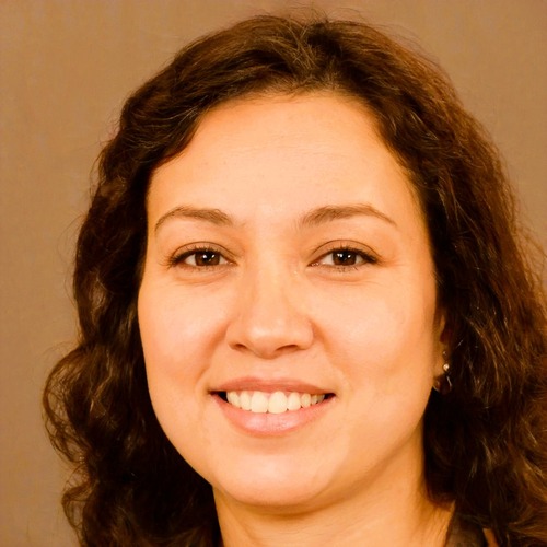 Author Photo of woman with brown curly hair and a smile